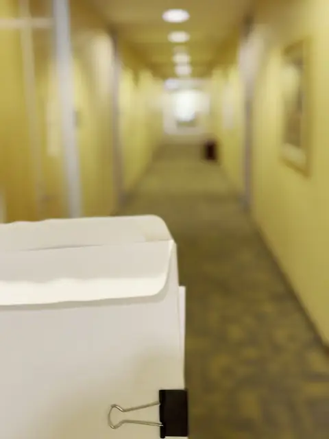 Process server in an office building hallway for a Pomona case