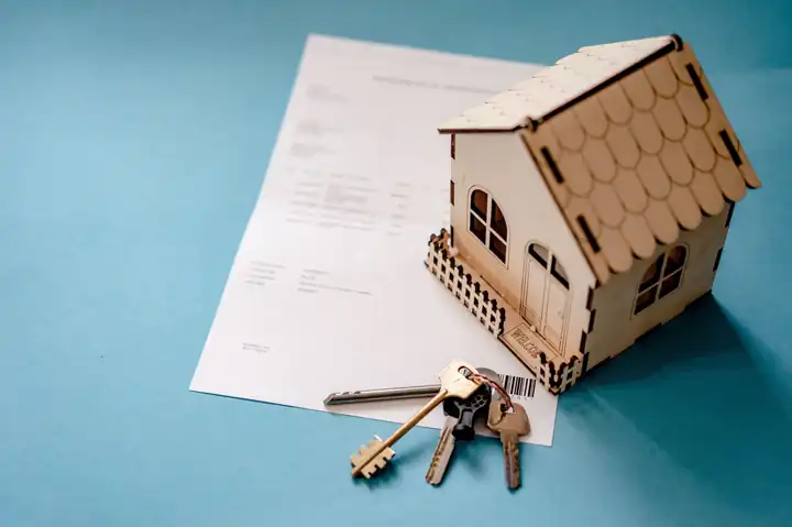 Model house with keys and a deed, representing a will and trust in California